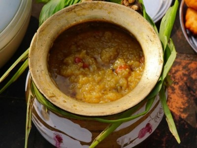 Bowl of golden daal curry garnished with coriander