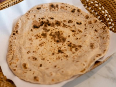 Closeup of a freshly made golden roti on a plate