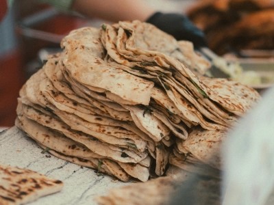 Stack of fresh rotis wrapped in cloth ready for delivery